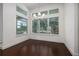 Bright dining room with dark wood floors, chandelier, and large windows with great views of the exterior at 25859 Crossings Bluff Ln, Sorrento, FL 32776