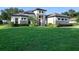 Beautiful single-story home with a manicured lawn, stone accents, and a tile roof at 25859 Crossings Bluff Ln, Sorrento, FL 32776