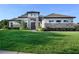 Stunning single-Gathering home featuring stone accents, manicured landscaping, and a well-maintained lawn at 25859 Crossings Bluff Ln, Sorrento, FL 32776