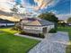 Beautiful exterior view of a home showcasing stone accents, a side entry garage and paver driveway at 25859 Crossings Bluff Ln, Sorrento, FL 32776