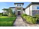 Paver walkway leads to a home with stone accents and lush landscaping at 25859 Crossings Bluff Ln, Sorrento, FL 32776