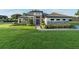 Charming single-Gathering home featuring stone accents, a well-manicured lawn, and a tiled roof at 25859 Crossings Bluff Ln, Sorrento, FL 32776