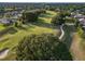 Scenic view of the lush green golf course surrounded by mature trees and beautiful homes at 25859 Crossings Bluff Ln, Sorrento, FL 32776
