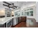 A modern kitchen is equipped with stainless steel appliances, granite countertops, and a view of the adjacent living area at 25859 Crossings Bluff Ln, Sorrento, FL 32776