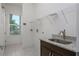 Convenient laundry room features a sink, storage, and natural light from a window at 25859 Crossings Bluff Ln, Sorrento, FL 32776