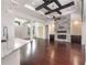 Open-concept living space with hardwood floors, stone fireplace, and coffered ceilings at 25859 Crossings Bluff Ln, Sorrento, FL 32776