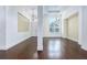 Bright living room with hardwood floors, decorative lighting and plenty of natural light from the large window at 25859 Crossings Bluff Ln, Sorrento, FL 32776