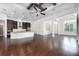 Open-concept living room with hardwood floors, coffered ceilings with dark beams, and seamless flow into the kitchen at 25859 Crossings Bluff Ln, Sorrento, FL 32776