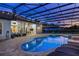 A private, screened-in pool area features comfortable lounge seating and ample deck space for entertaining at 25859 Crossings Bluff Ln, Sorrento, FL 32776