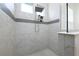 Walk-in shower with double shower head and decorative tiled accent strip at 25859 Crossings Bluff Ln, Sorrento, FL 32776