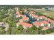 Aerial view showcasing a lakefront community with mature trees and terracotta roofs at 2627 Maitland Crossing Way # 101, Orlando, FL 32810