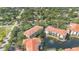 Aerial view of community featuring mature trees, lake, fountain, and red tile roofs at 2627 Maitland Crossing Way # 101, Orlando, FL 32810