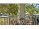 Balcony view with outdoor seating overlooking lush greenery and parking area at 2627 Maitland Crossing Way # 101, Orlando, FL 32810