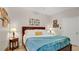 Bedroom with wood trim bed, throw blanket, decorative art, and ample natural light at 2627 Maitland Crossing Way # 101, Orlando, FL 32810