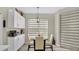 Bright breakfast nook featuring a modern light fixture and decorative window shades at 2627 Maitland Crossing Way # 101, Orlando, FL 32810