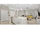 Modern kitchen featuring white cabinetry, stainless steel appliances, and an island with bar seating at 2627 Maitland Crossing Way # 101, Orlando, FL 32810