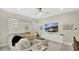 Bright living room featuring a plush gray sofa, modern wall decor, and large windows with shades at 2627 Maitland Crossing Way # 101, Orlando, FL 32810
