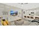 Open-concept living room with modern furnishings flowing into a bright kitchen area at 2627 Maitland Crossing Way # 101, Orlando, FL 32810