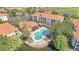 Aerial view of a pool in a community featuring lush landscaping and a serene lakeside setting at 2627 Maitland Crossing Way # 101, Orlando, FL 32810