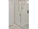 Shower with clear glass doors and white tiled walls at 2835 Mosshire Cir, St Cloud, FL 34772