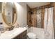 Stylish bathroom with modern vanity, decorative mirror, and tiled shower/tub combination at 2903 Willow Oak Ct, Kissimmee, FL 34744