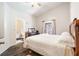 This bright bedroom features a vaulted ceiling, wood floors, and an ensuite bathroom at 2903 Willow Oak Ct, Kissimmee, FL 34744
