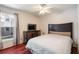 This bedroom features hardwood floors, a ceiling fan and a large window offering lots of natural light at 2903 Willow Oak Ct, Kissimmee, FL 34744