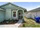 Inviting front entry with an arched covered doorway and flower bed at 2903 Willow Oak Ct, Kissimmee, FL 34744