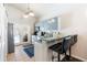 This eat-in kitchen features bar seating, stainless steel appliances and a door to the pool area at 2903 Willow Oak Ct, Kissimmee, FL 34744