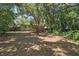 Expansive, shaded backyard with mature trees, offering privacy and natural beauty for outdoor enjoyment at 2915 Hargill Dr, Orlando, FL 32806