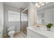 Bright bathroom featuring large mirror, single vanity, and tiled walk-in shower at 2915 Hargill Dr, Orlando, FL 32806