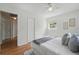 This bedroom features hardwood floors, a ceiling fan, and an ensuite bathroom at 2915 Hargill Dr, Orlando, FL 32806