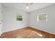 Empty bedroom features hardwood floors, two windows, and neutral paint at 2915 Hargill Dr, Orlando, FL 32806