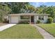 Charming single-story home with a well-maintained lawn and attached garage at 2915 Hargill Dr, Orlando, FL 32806