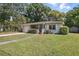 Well-kept single-story home with lush green lawn and mature trees at 2915 Hargill Dr, Orlando, FL 32806