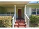Inviting front porch with steps and a red door at 2915 Hargill Dr, Orlando, FL 32806