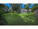Backyard with large lawn area, fencing and screened-in pool area at 2928 Ne 14Th Ave, Ocala, FL 34479