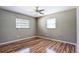 Empty bedroom exhibiting wood-look floors, neutral paint, windows and ceiling fan at 2928 Ne 14Th Ave, Ocala, FL 34479