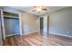Bedroom featuring wood-look floors, neutral paint and a closet with folding doors at 2928 Ne 14Th Ave, Ocala, FL 34479