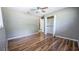 Bedroom displaying wood-look floors, neutral paint, windows and a ceiling fan at 2928 Ne 14Th Ave, Ocala, FL 34479