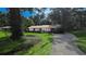 Charming single story home boasts mature landscaping and a well-maintained front yard, with covered entry at 2928 Ne 14Th Ave, Ocala, FL 34479