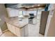 Updated kitchen with modern appliances, granite countertops, and tile flooring at 2928 Ne 14Th Ave, Ocala, FL 34479