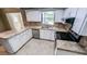 Bright kitchen featuring white cabinetry, stainless steel appliances, and tile countertops at 2928 Ne 14Th Ave, Ocala, FL 34479