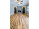 Open living room featuring hardwood floors, brick fireplace, and built-in shelving at 2928 Ne 14Th Ave, Ocala, FL 34479