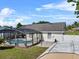 Aerial view of a home with a screened-in pool and fenced backyard at 2966 Derby Dr, Deltona, FL 32738