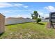 Fenced backyard with well-manicured lawn and landscaping at 2966 Derby Dr, Deltona, FL 32738