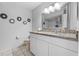 Well-lit bathroom featuring a granite vanity and decorative wall art at 2966 Derby Dr, Deltona, FL 32738