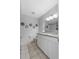 Well-lit bathroom features tile flooring, granite counters and double sink vanity at 2966 Derby Dr, Deltona, FL 32738