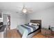 Bright bedroom with ceiling fan, white closet doors, and wood floors at 2966 Derby Dr, Deltona, FL 32738