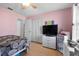 Bright bedroom with a ceiling fan, closet and a large TV at 2966 Derby Dr, Deltona, FL 32738